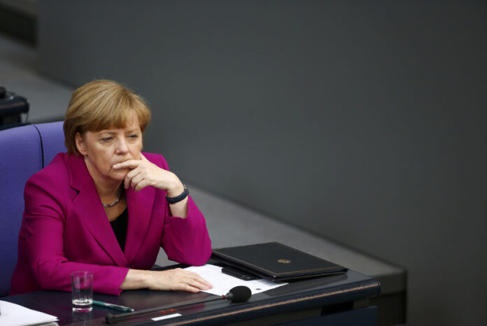 German Chancellor Merkel listens to a speaker during Bundestag session in Berlin